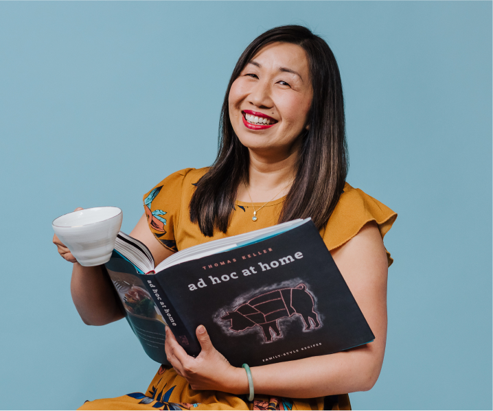 An reading a book called "ad hoc at home".